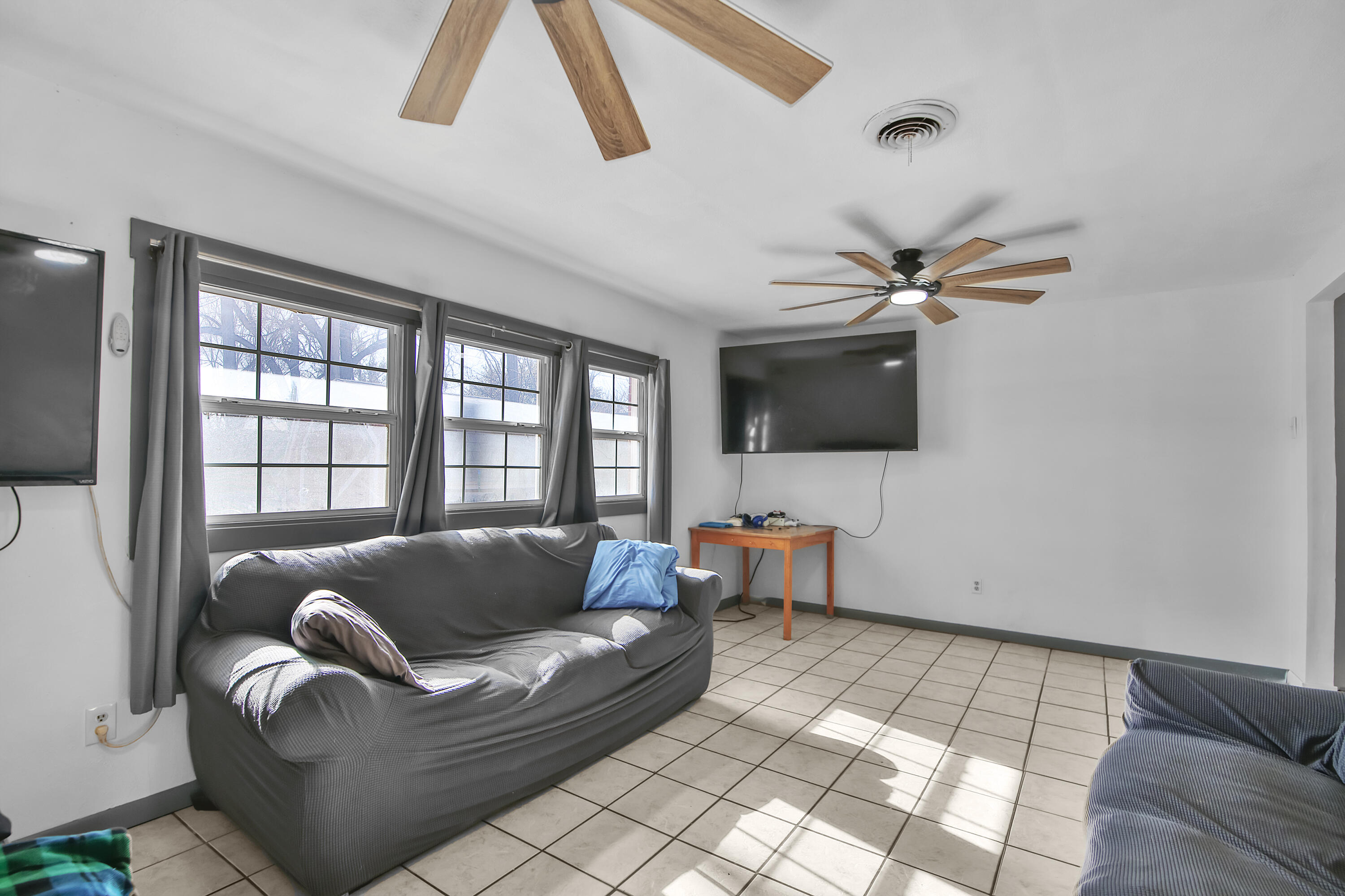 2801 52nd Street Lubbock, TX 79413 - Photo 14 of 34 a living room with furniture and a flat screen tv