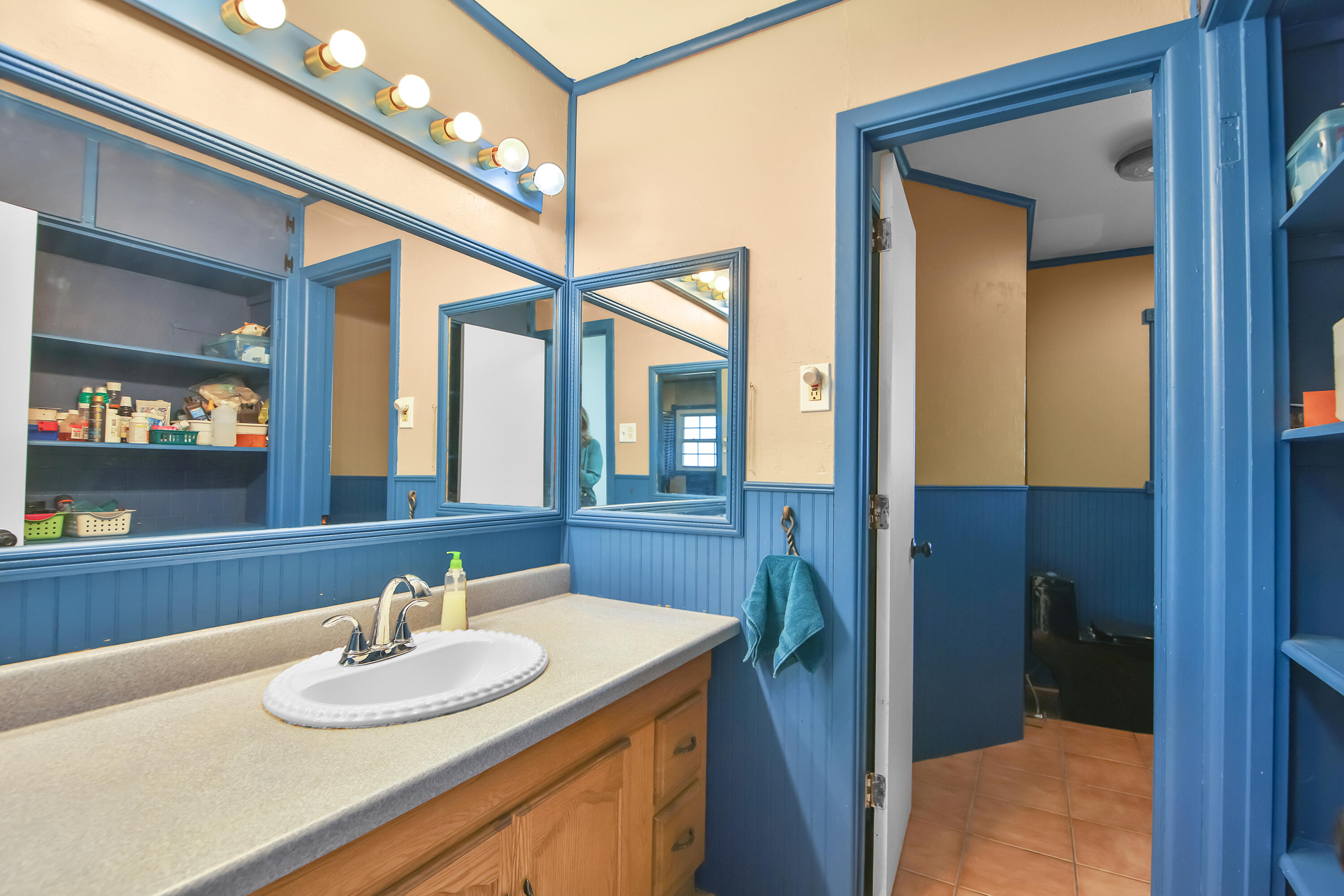 2801 52nd Street Lubbock, TX 79413 - Photo 15 of 34 a bathroom with a granite countertop sink and a mirror