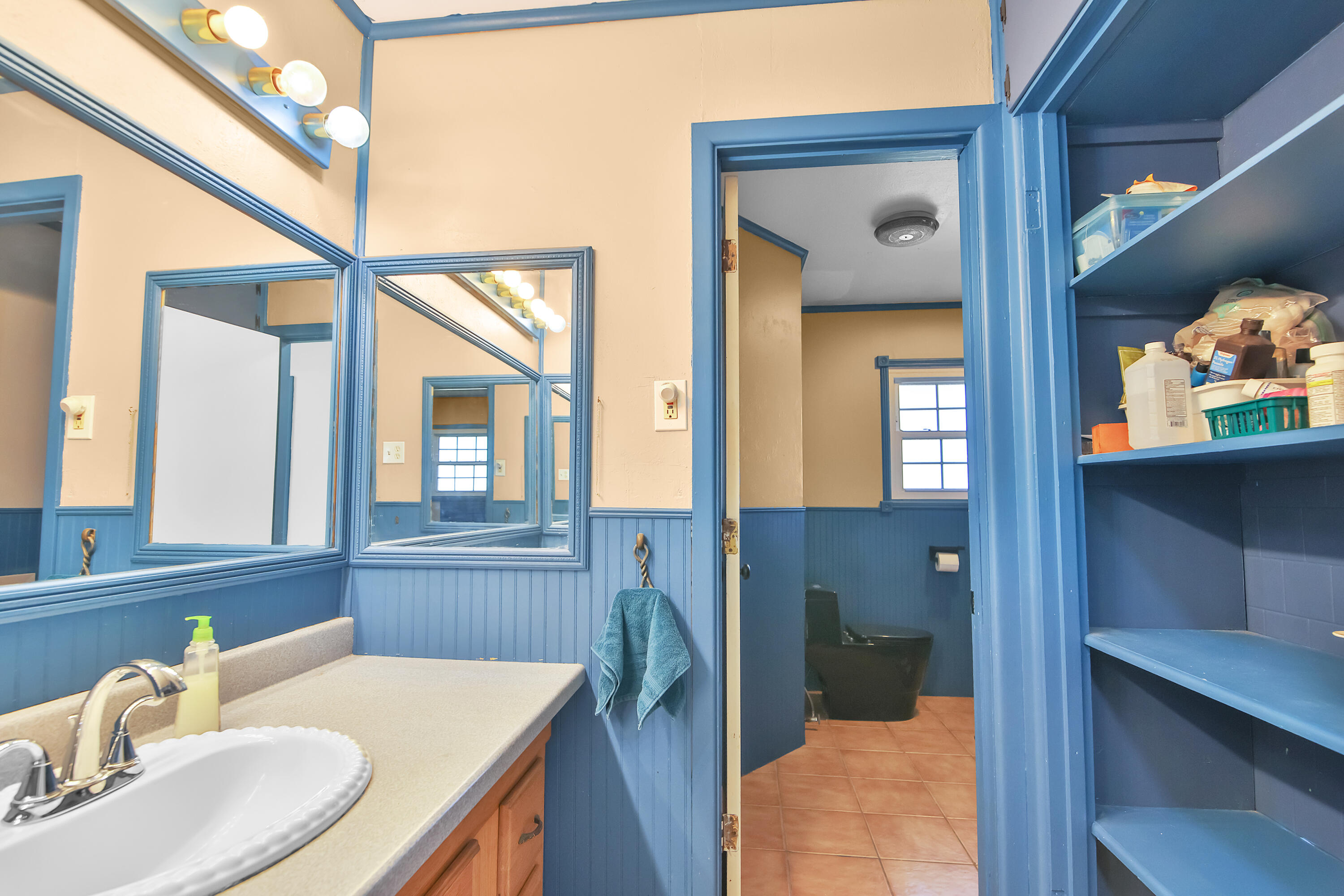 2801 52nd Street Lubbock, TX 79413 - Photo 16 of 34 a bathroom with a sink a vanity and a mirror