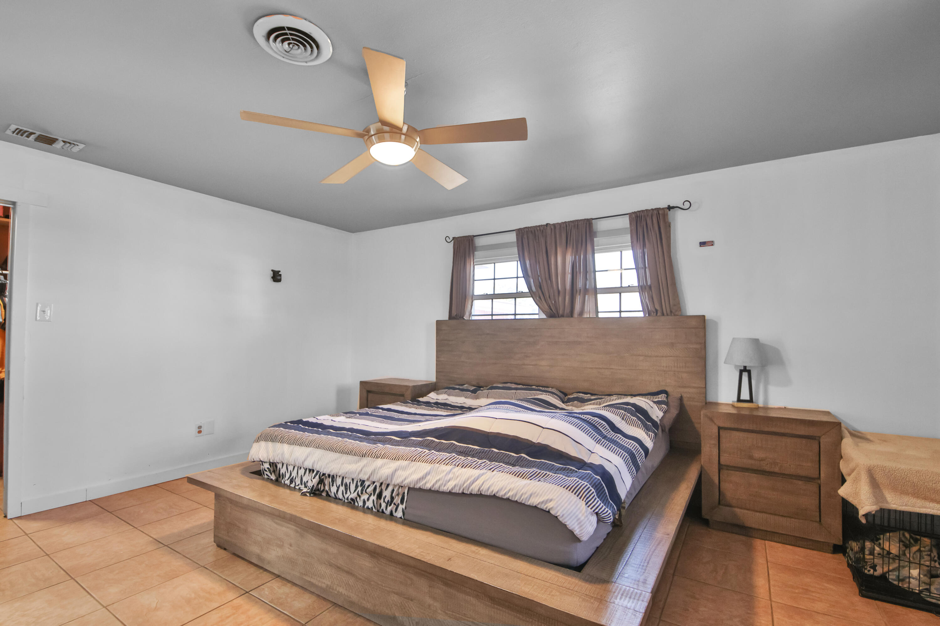2801 52nd Street Lubbock, TX 79413 - Photo 23 of 34 a bedroom with a bed and a chandelier