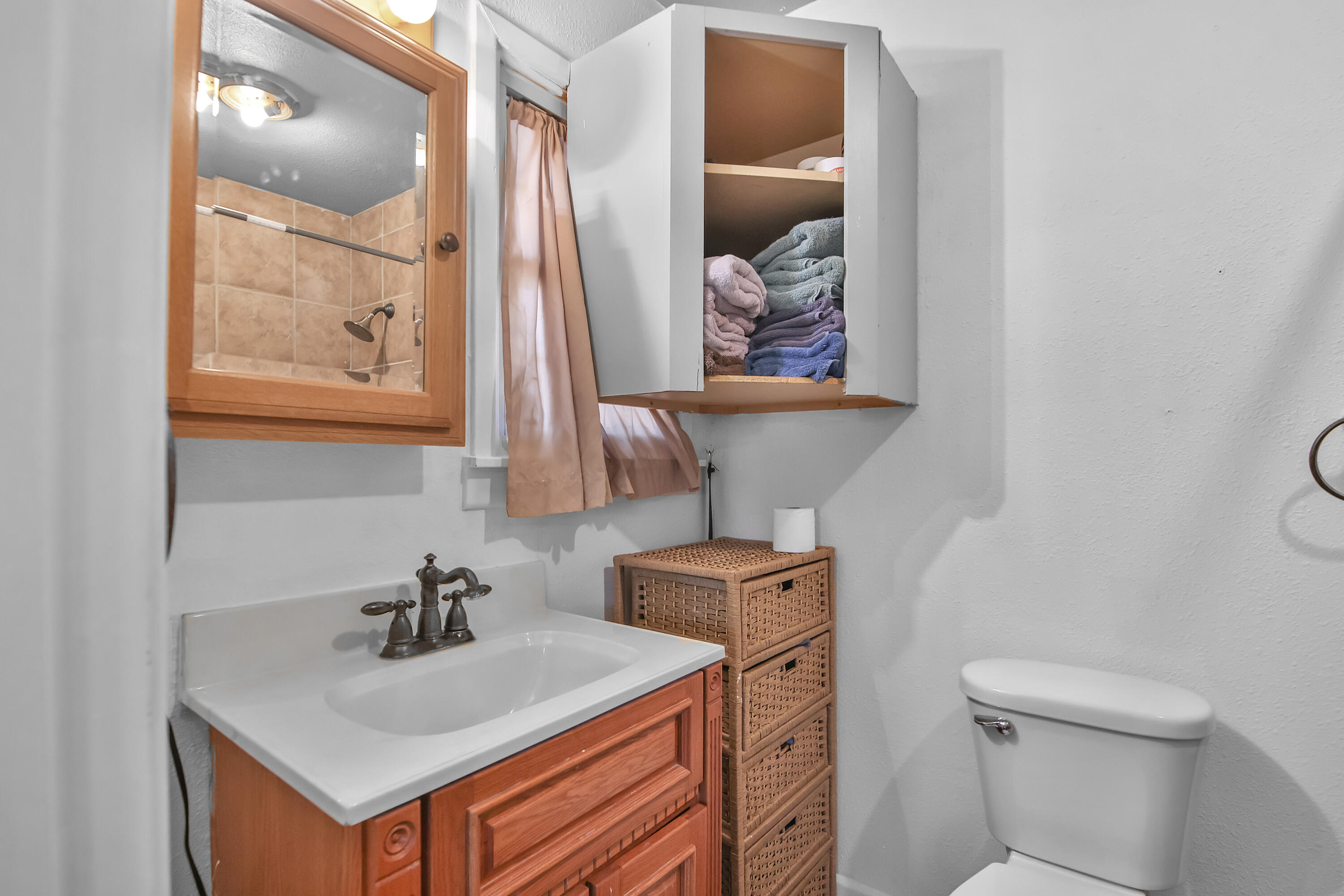 2801 52nd Street Lubbock, TX 79413 - Photo 24 of 34 a bathroom with a toilet sink and mirror