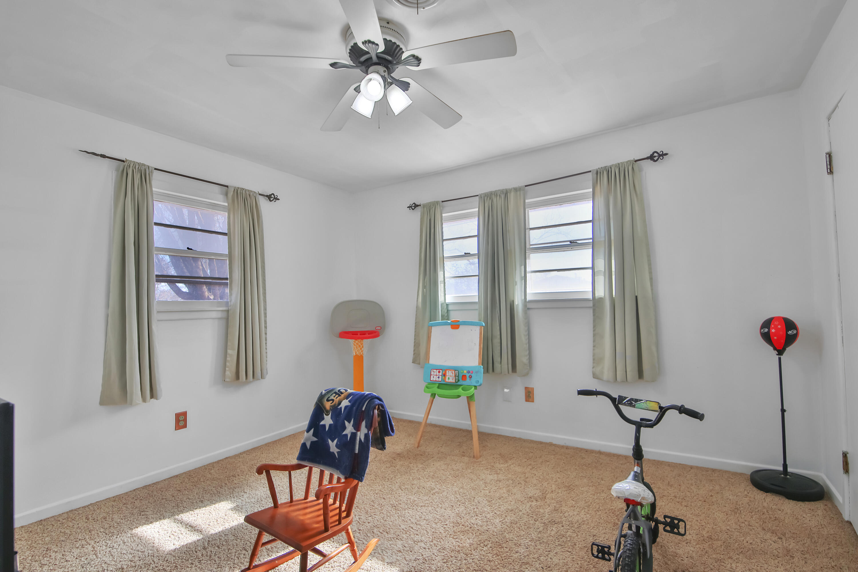 2801 52nd Street Lubbock, TX 79413 - Photo 26 of 34 a living room with furniture a window and gym equipment