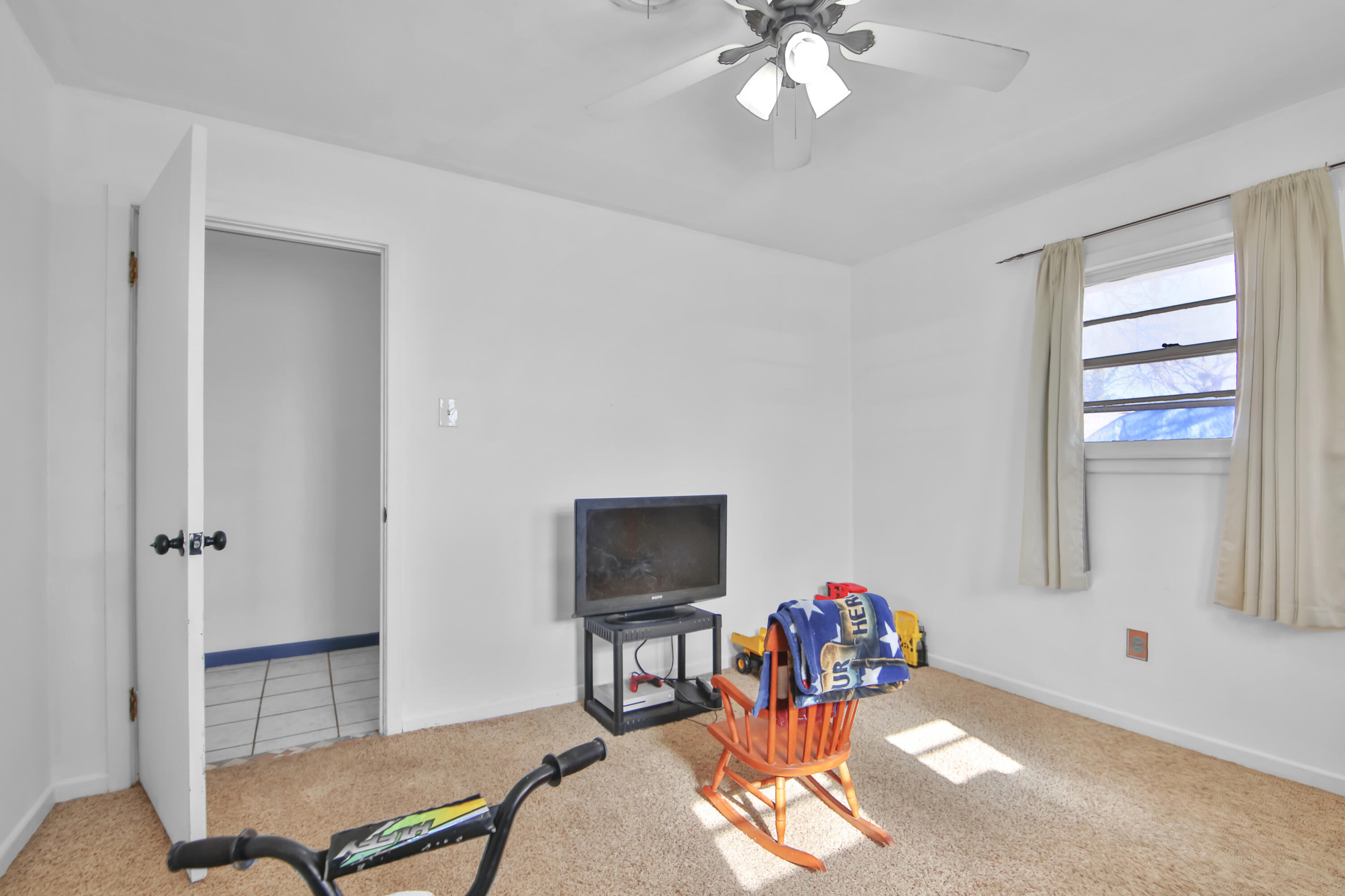 2801 52nd Street Lubbock, TX 79413 - Photo 27 of 34 a living room with furniture and a flat screen tv