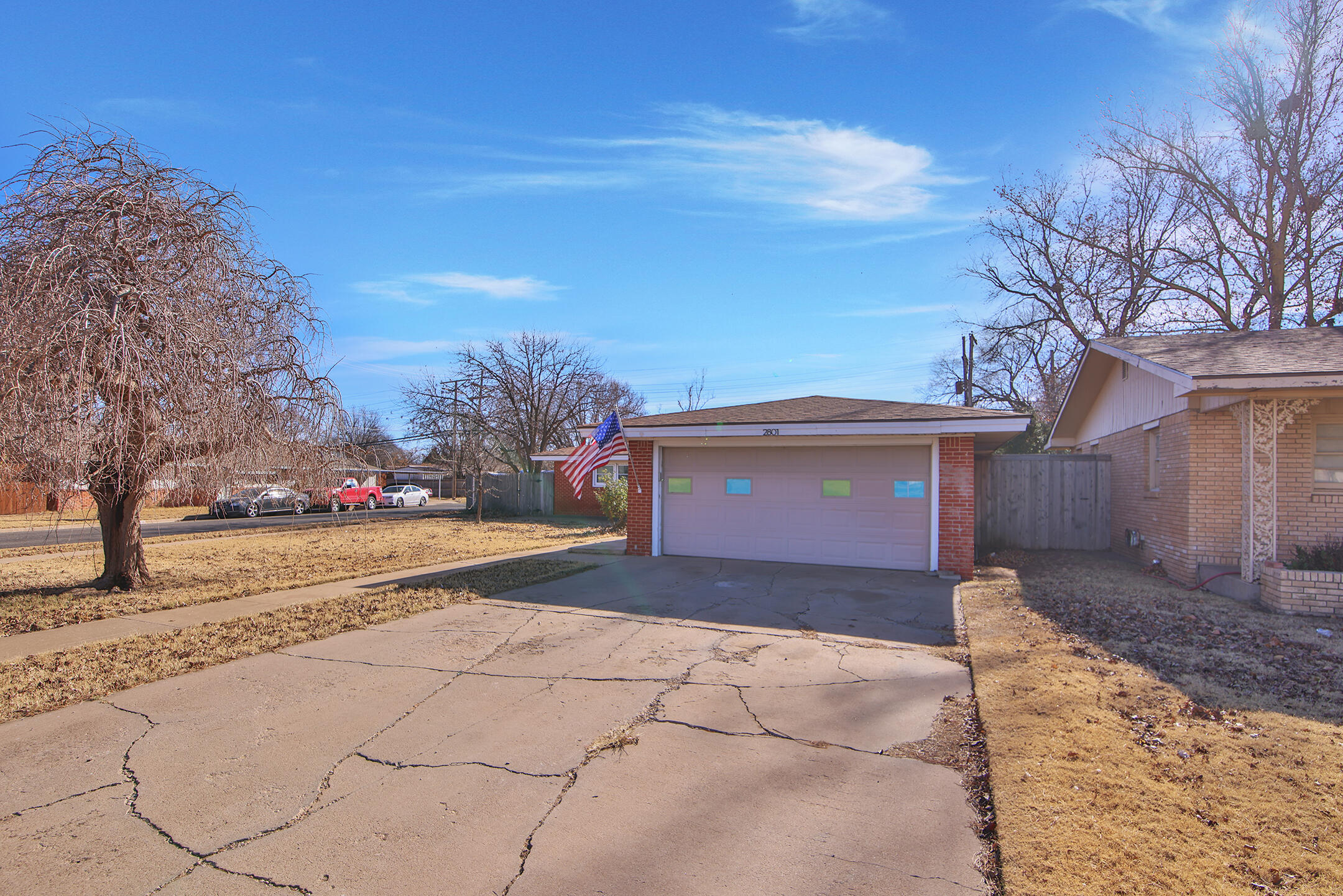 2801 52nd Street Lubbock, TX 79413 - Photo 3 of 34 a front view of a house with a yard and garage