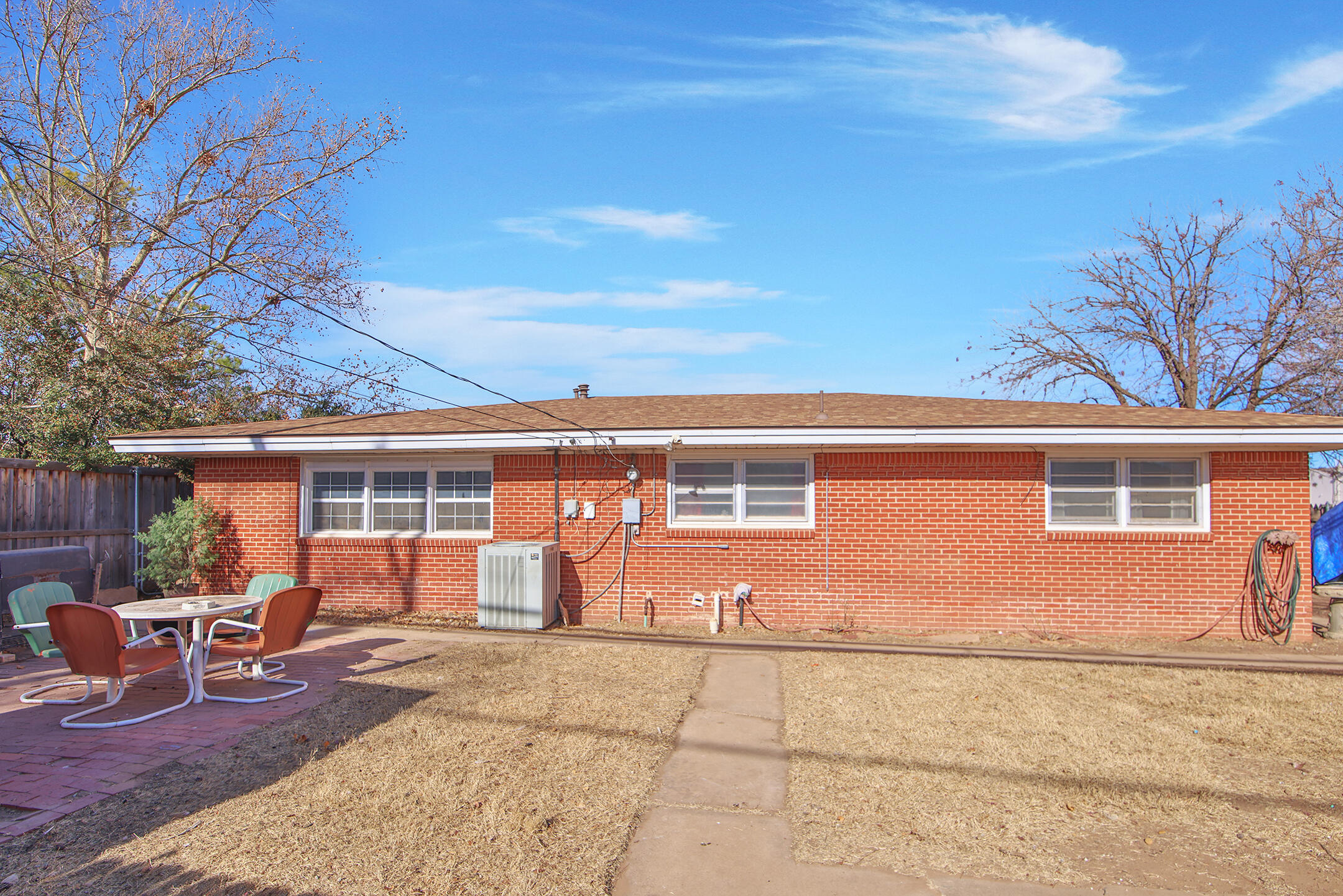 2801 52nd Street Lubbock, TX 79413 - Photo 31 of 34 a backyard of a house with table and chairs