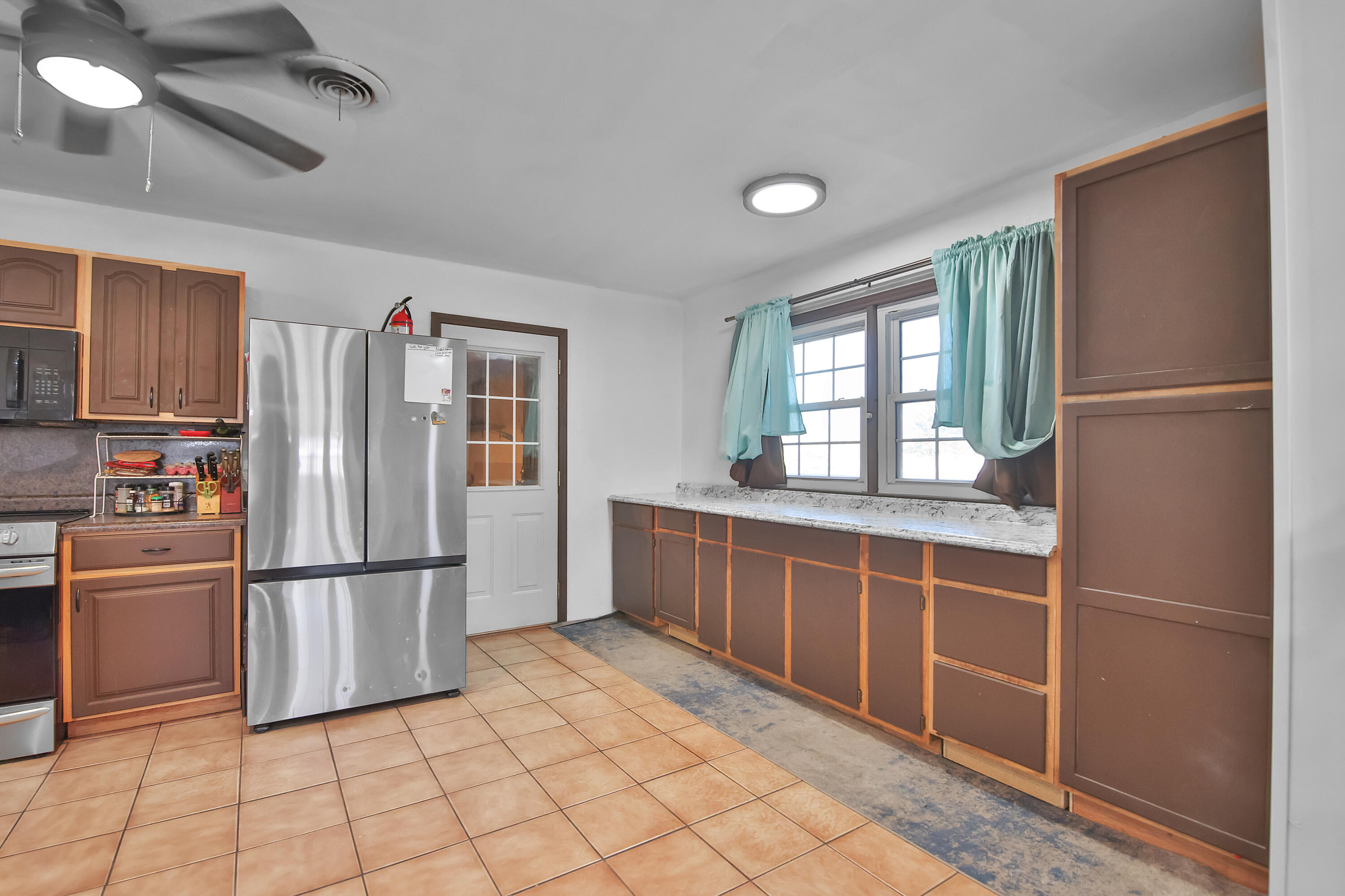 2801 52nd Street Lubbock, TX 79413 - Photo 8 of 34 a kitchen with stainless steel appliances granite countertop a refrigerator and a sink