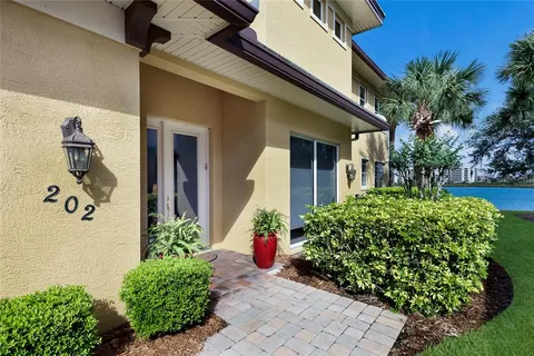 a view of a house with potted plants