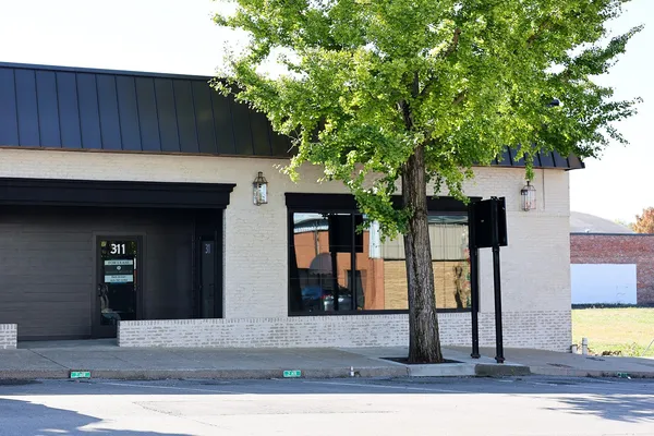 a house that has a tree in front of it