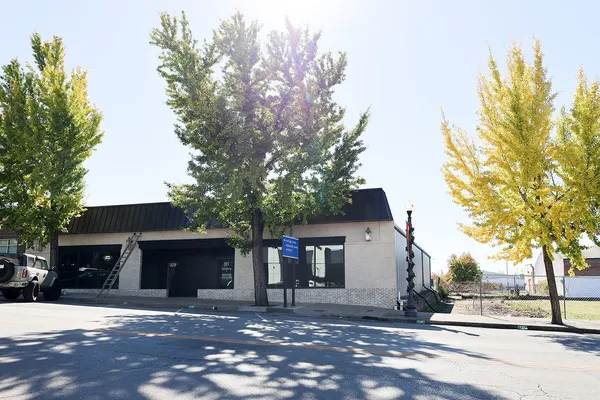 a front view of a house with a tree
