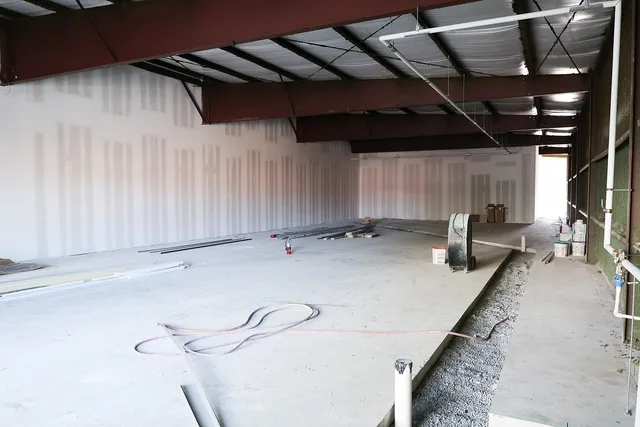 a spacious bedroom with a bed and a window