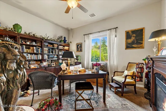 a work room with furniture and a bookshelf