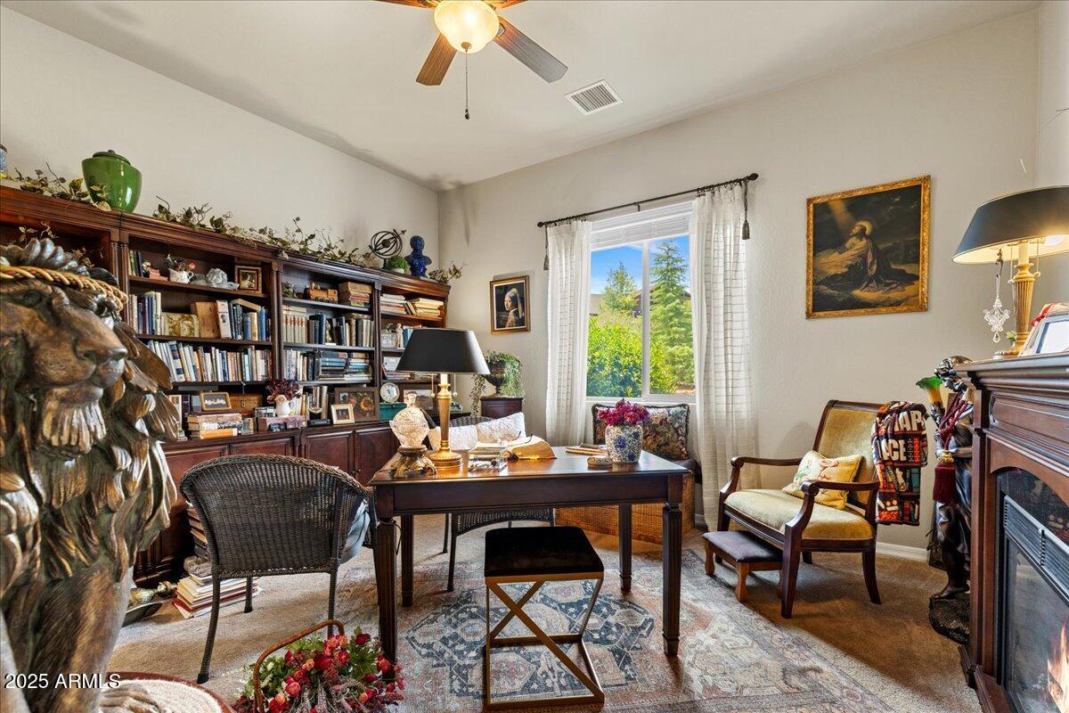 2135 West Bridle Path Road Prescott, AZ 86305 - Photo 18 of 32 a work room with furniture and a bookshelf
