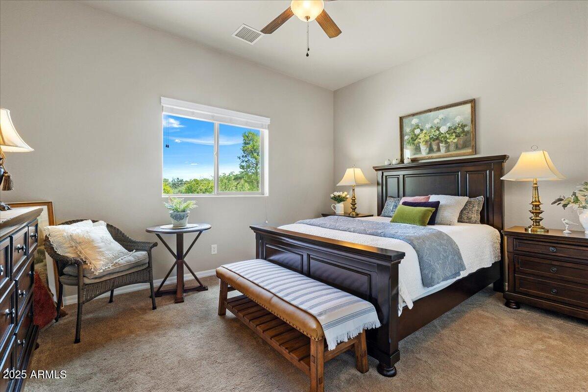 2135 West Bridle Path Road Prescott, AZ 86305 - Photo 19 of 32 a bedroom with a bed and a chandelier