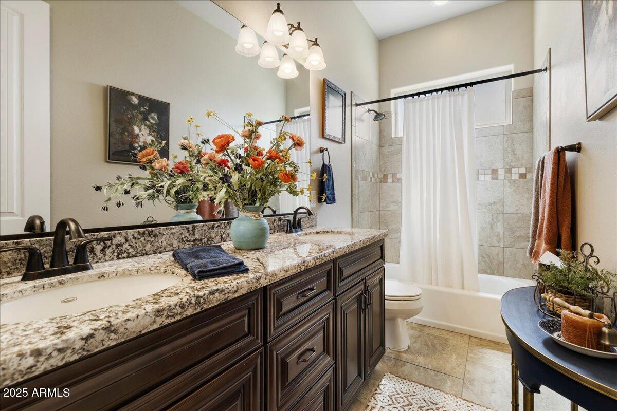 2135 West Bridle Path Road Prescott, AZ 86305 - Photo 20 of 32 a bathroom with a granite countertop sink a large mirror and a bathtub
