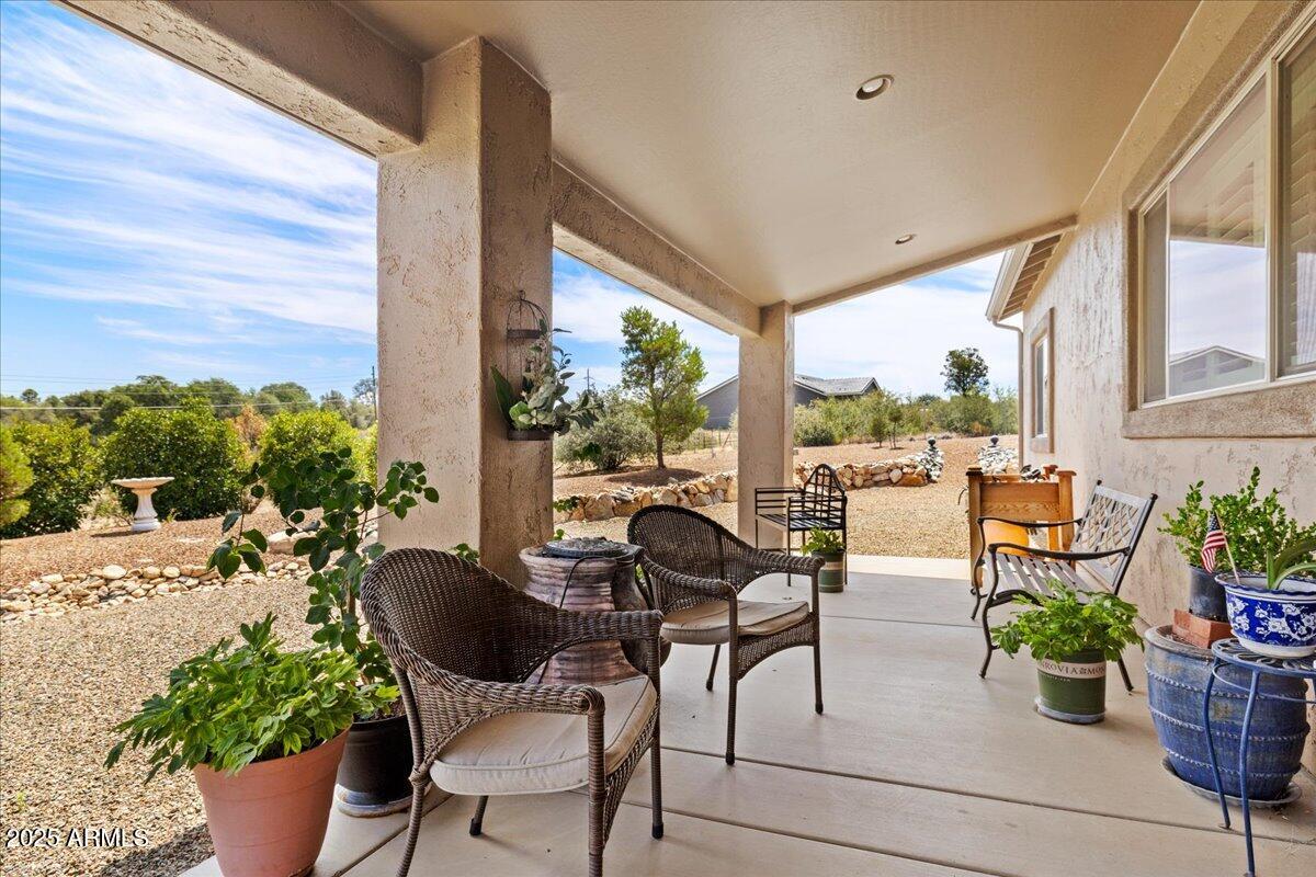 2135 West Bridle Path Road Prescott, AZ 86305 - Photo 23 of 32 a view of a porch with chairs and potted plants