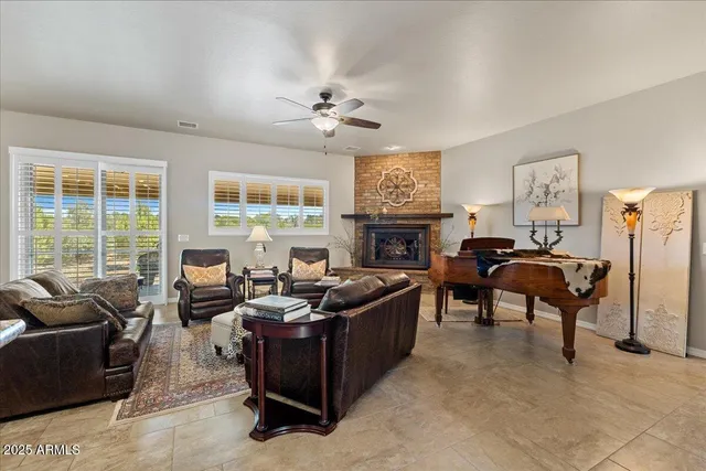 a living room with furniture flat screen tv and a fireplace
