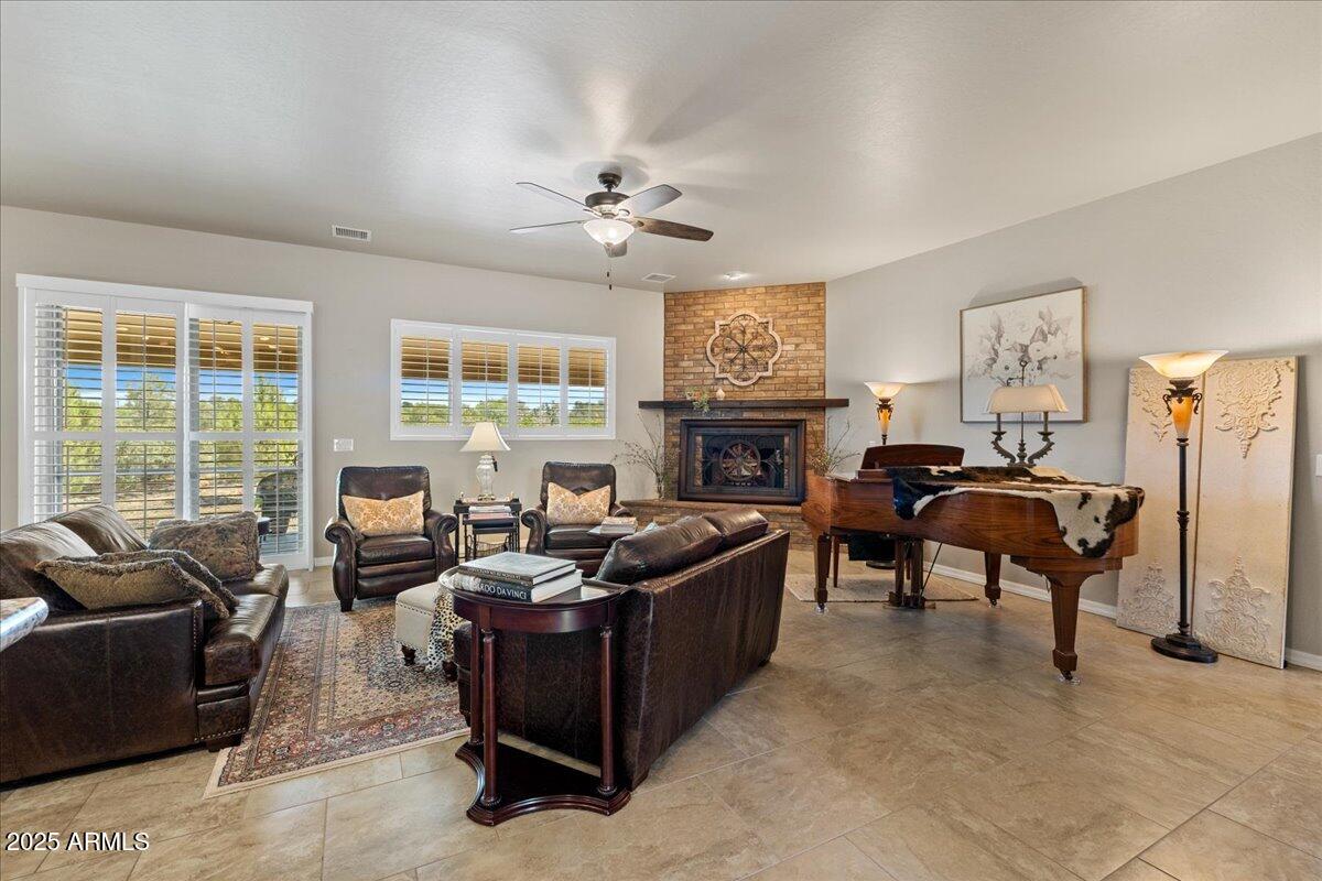 2135 West Bridle Path Road Prescott, AZ 86305 - Photo 3 of 32 a living room with furniture flat screen tv and a fireplace