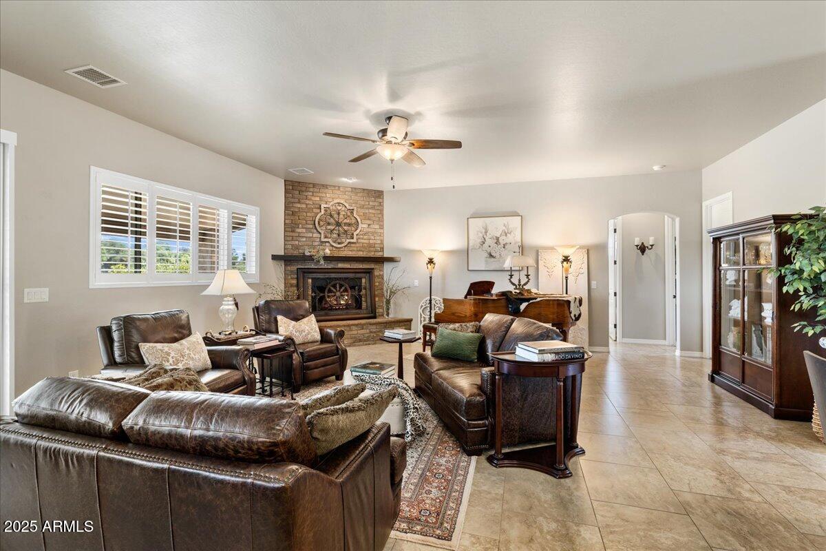 2135 West Bridle Path Road Prescott, AZ 86305 - Photo 4 of 32 a living room with furniture and a fireplace