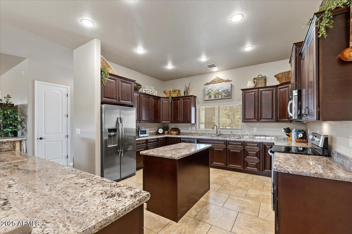 2135 West Bridle Path Road Prescott, AZ 86305 - Photo 7 of 32 a kitchen with granite countertop a sink stove and refrigerator