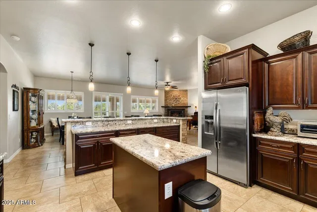 a kitchen with stainless steel appliances granite countertop a sink a stove and a refrigerator