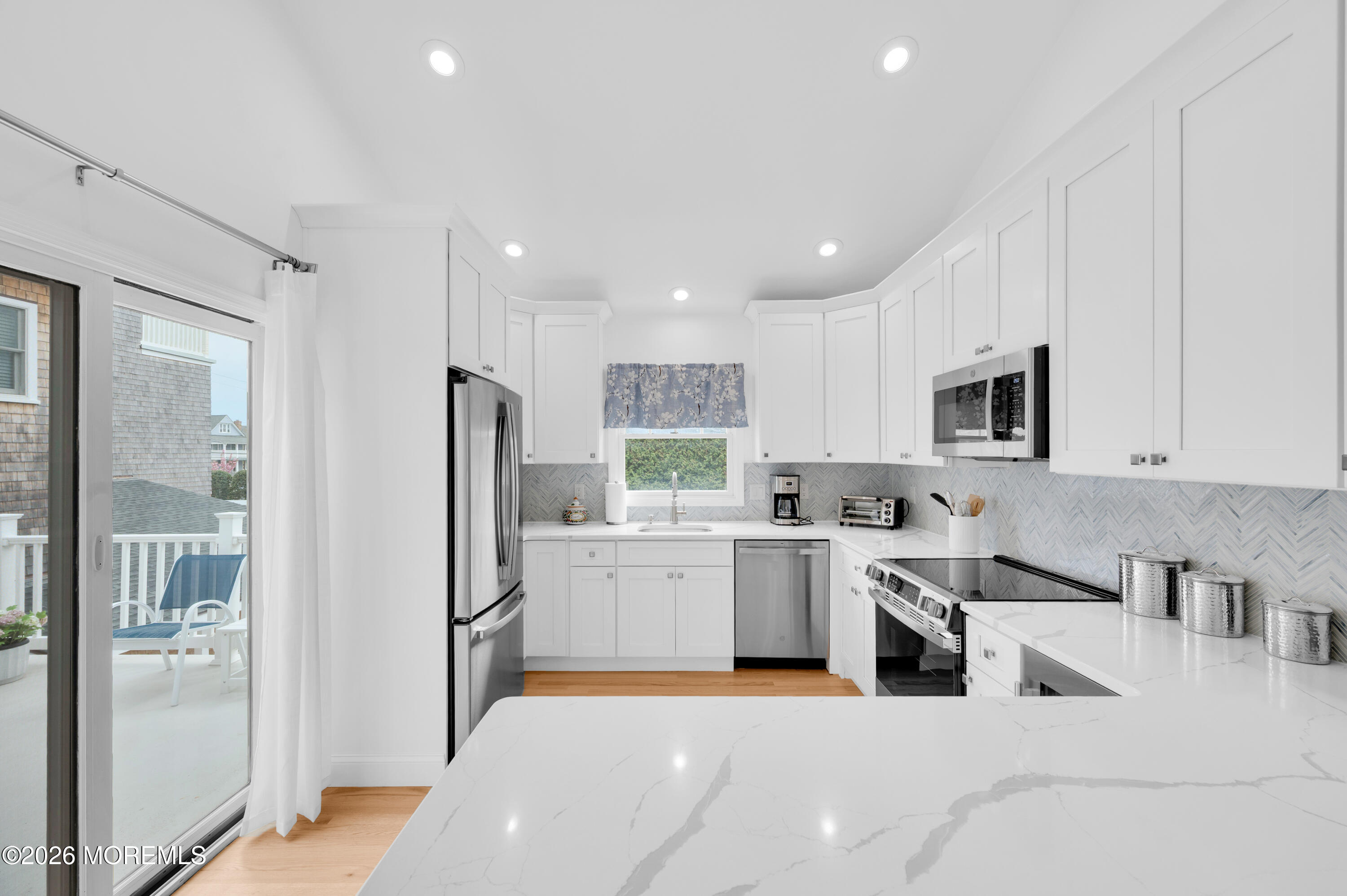 41 A Mount Street Bay Head, NJ 08742 - Photo 4 of 33 a kitchen with white cabinets and stainless steel appliances