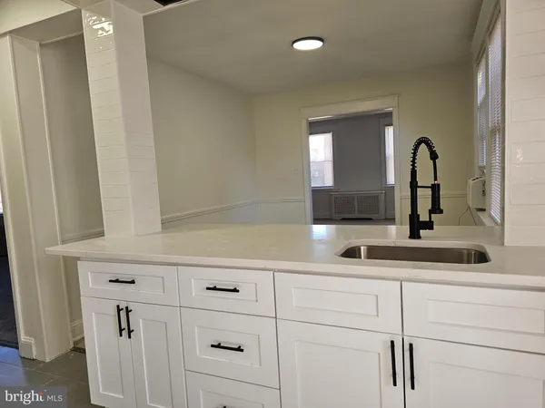 a bathroom with a sink and two mirror