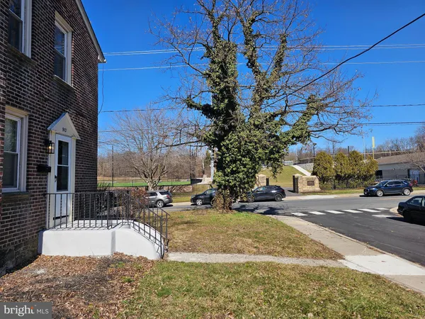 a view of road with large trees