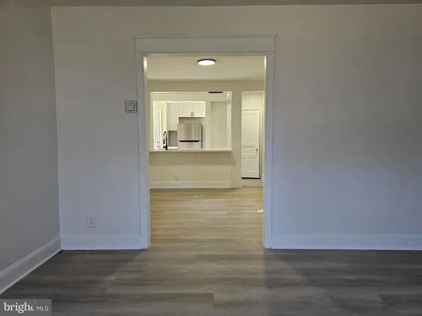 a view of wooden floor and cabinet in a room