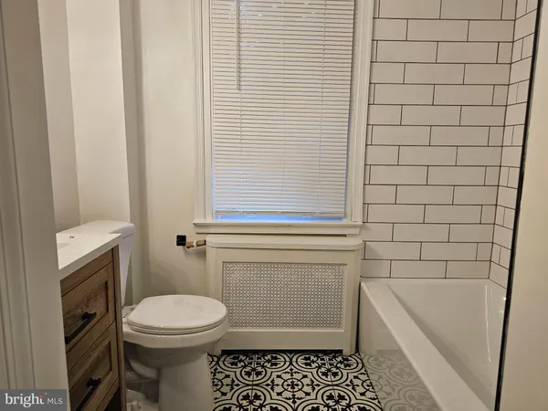 a bathroom with a sink a toilet and bathtub