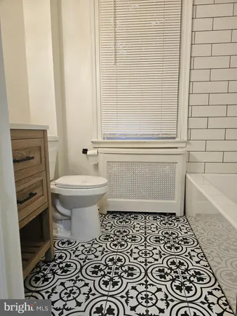 a bathroom with a toilet a sink and bathtub