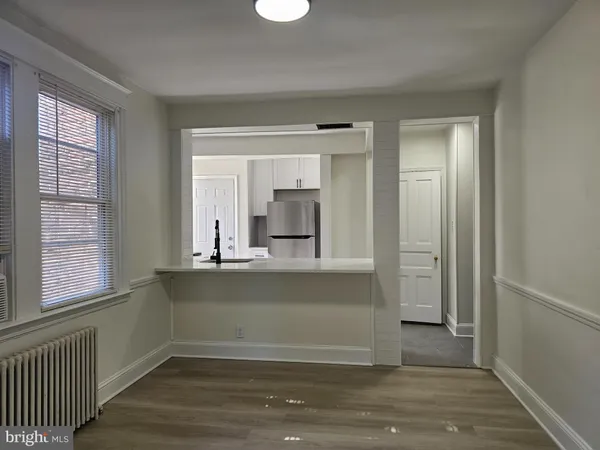 a view of kitchen with granite countertop cabinets and window