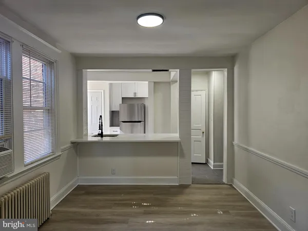 a view of kitchen and hall with wooden floor