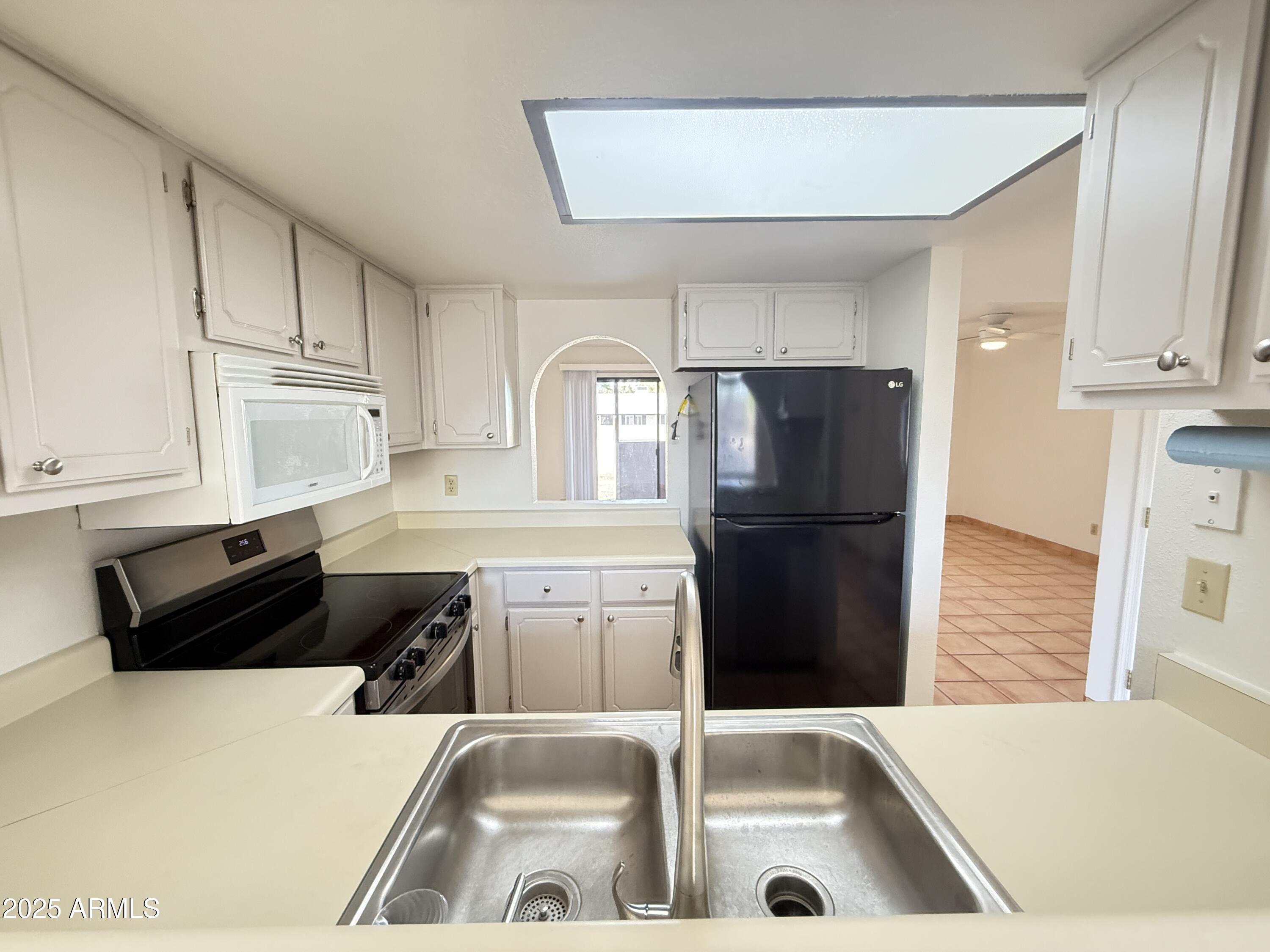 611 West 13th Street Tempe, AZ 85281 - Photo 20 of 30 a kitchen with a refrigerator a stove a sink and a cabinets