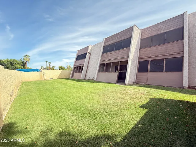 a swimming pool with outdoor seating and yard