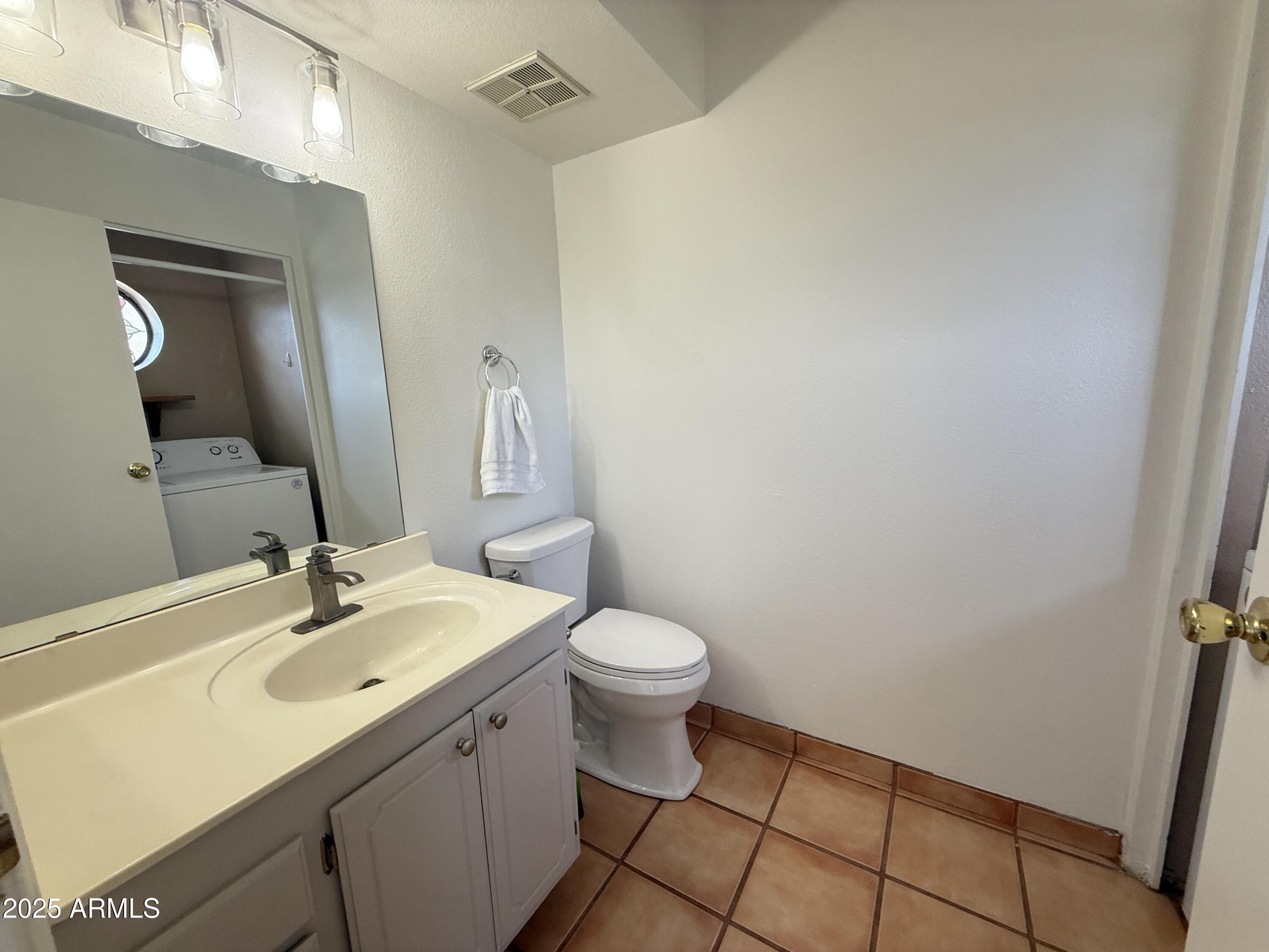 611 West 13th Street Tempe, AZ 85281 - Photo 24 of 30 a bathroom with a sink a toilet and mirror