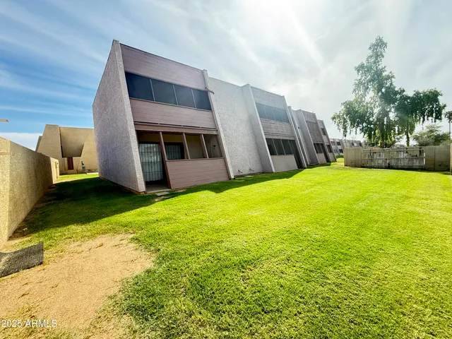 a view of an house with backyard and porch