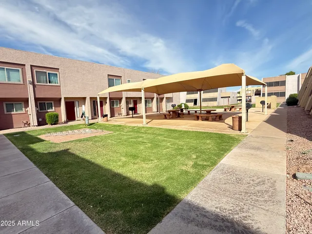 a view of a building with a yard