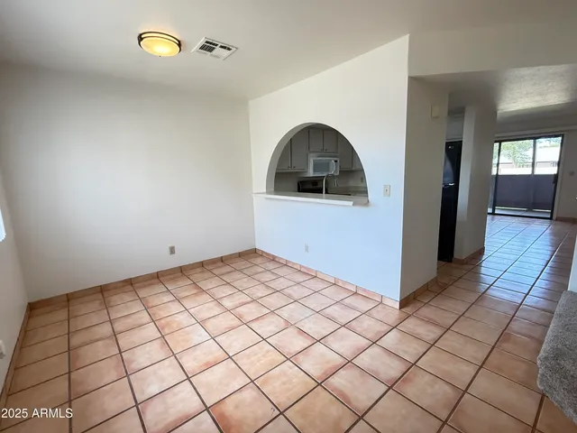 a view of a livingroom with wooden floor and entryway