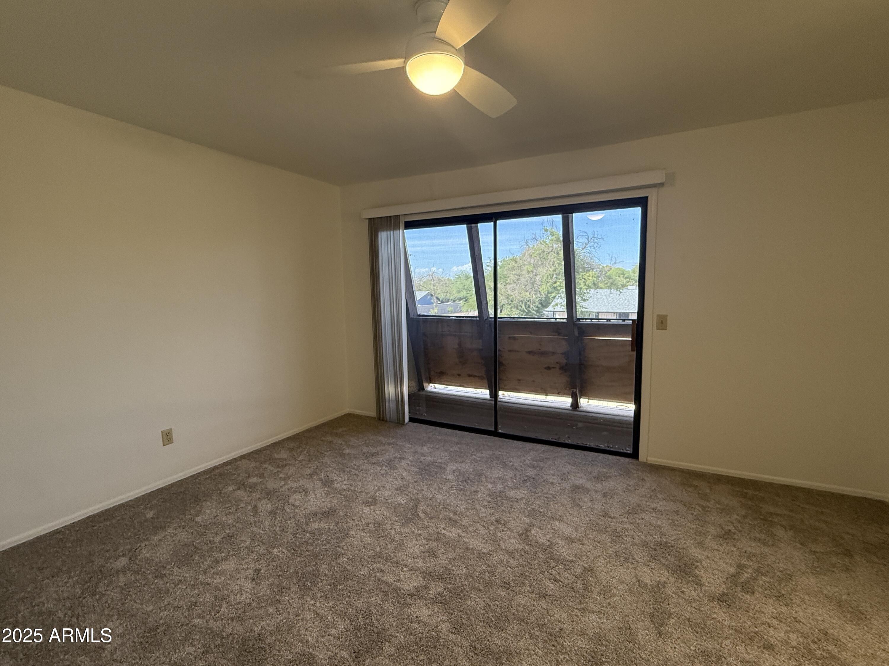611 West 13th Street Tempe, AZ 85281 - Photo 9 of 30 an empty room with chandelier fan and windows