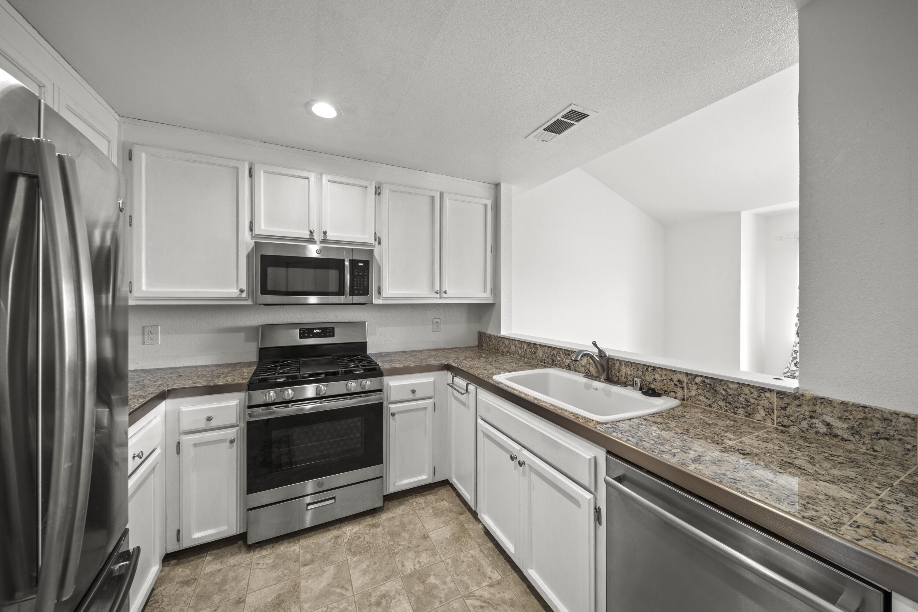 6014 Mid Drive Trail Redding, CA 96003 - Photo 5 of 15 a kitchen with granite countertop a sink stove and refrigerator