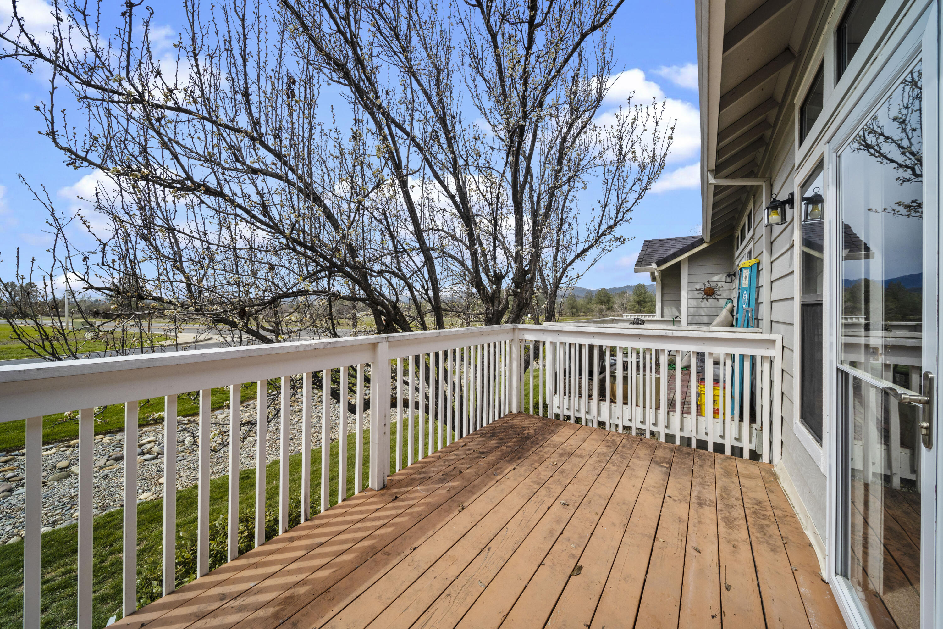 6014 Mid Drive Trail Redding, CA 96003 - Photo 9 of 15 a view of deck with wooden fence and trees