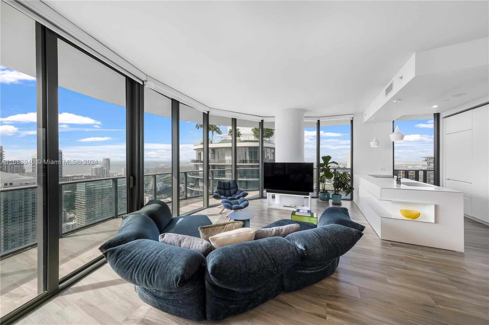 Brickell Miami, FL 33131 - Photo 3 of 13 a living room with furniture and a flat screen tv