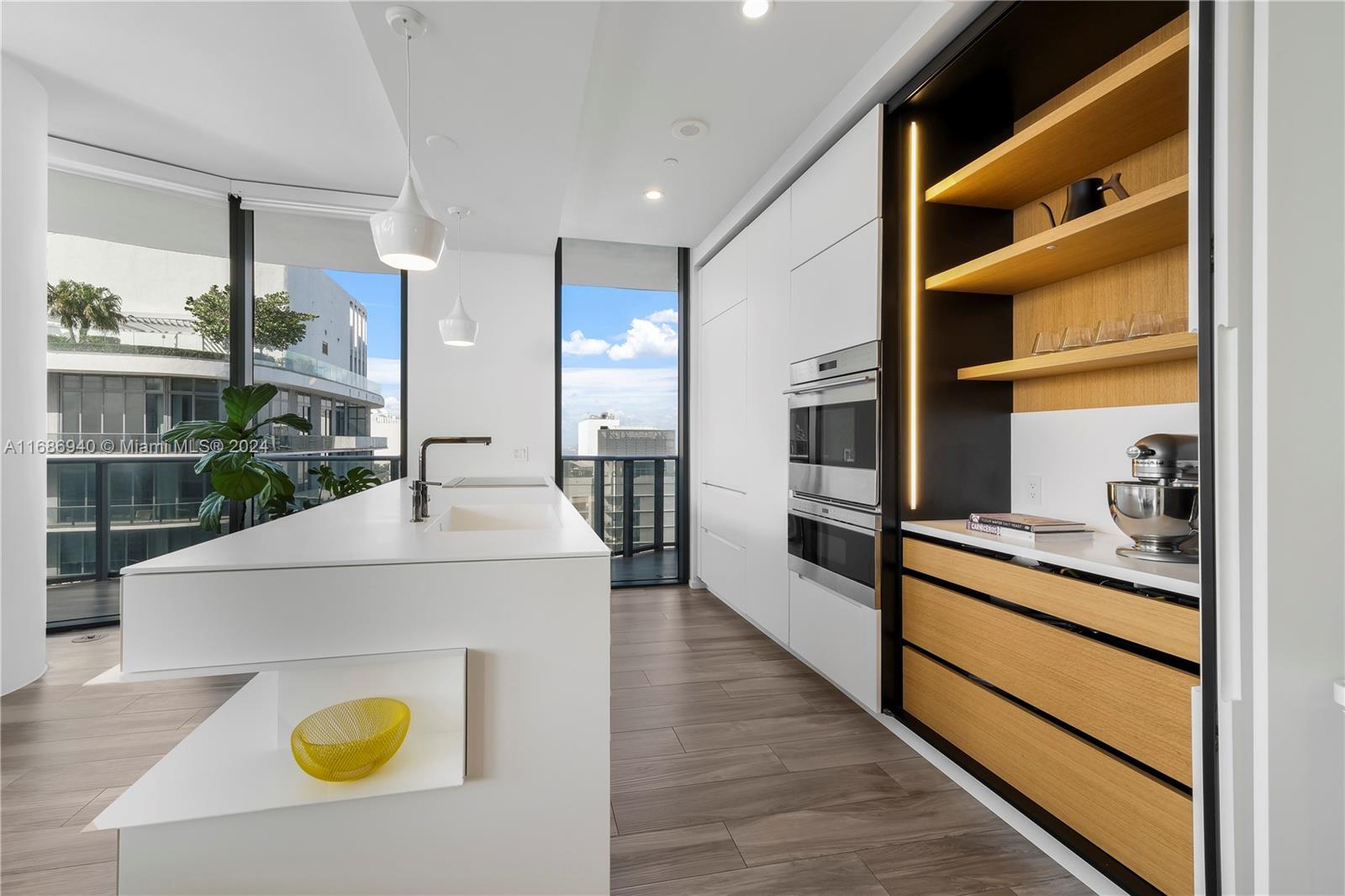 Brickell Miami, FL 33131 - Photo 4 of 13 a kitchen with a sink a stove and refrigerator