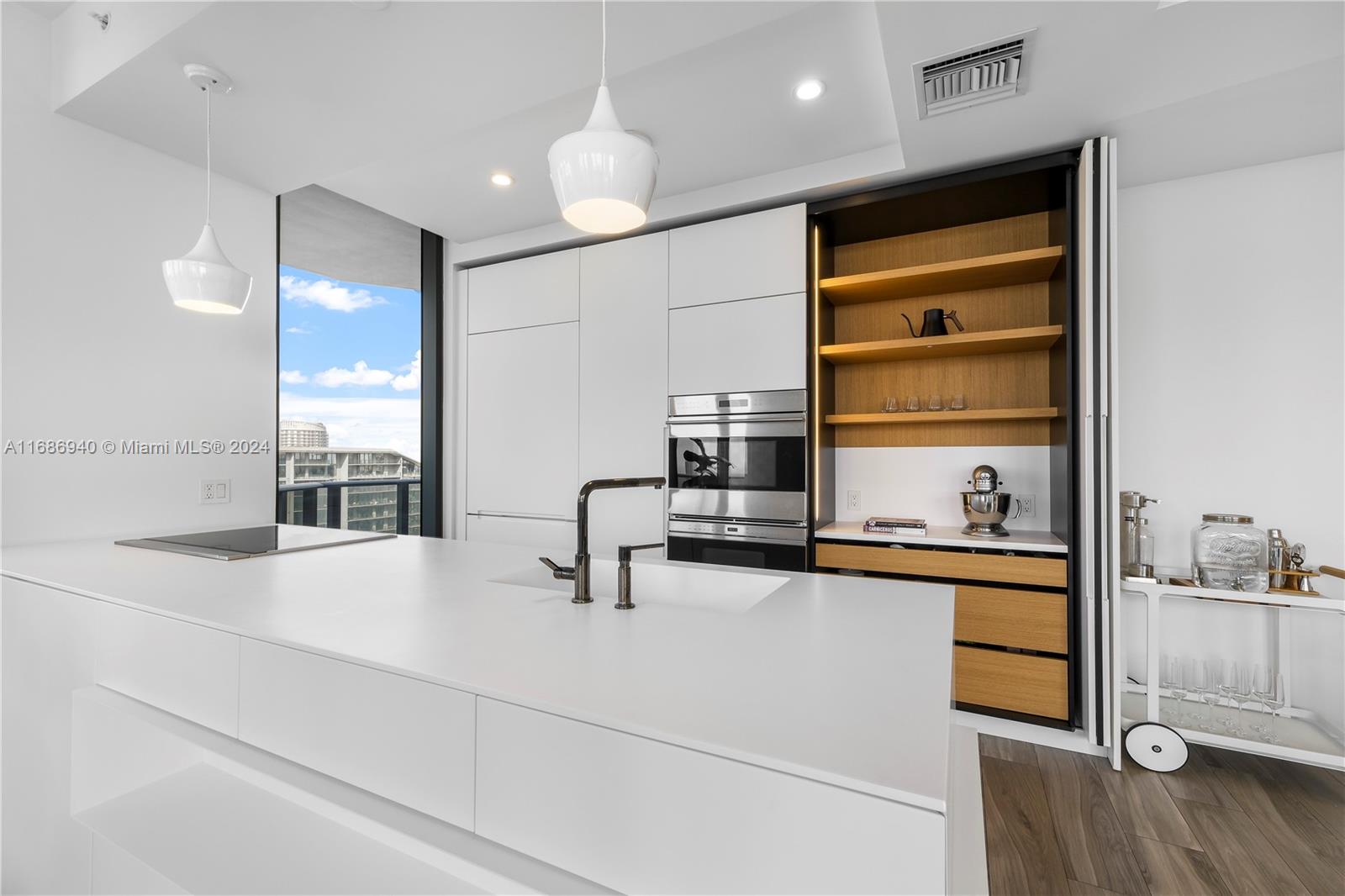 Brickell Miami, FL 33131 - Photo 6 of 13 a kitchen with a sink cabinets and window
