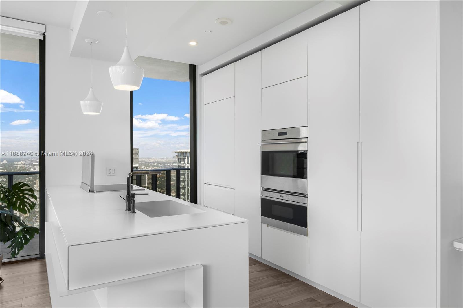 Brickell Miami, FL 33131 - Photo 7 of 13 a kitchen with kitchen island a counter appliances and cabinets
