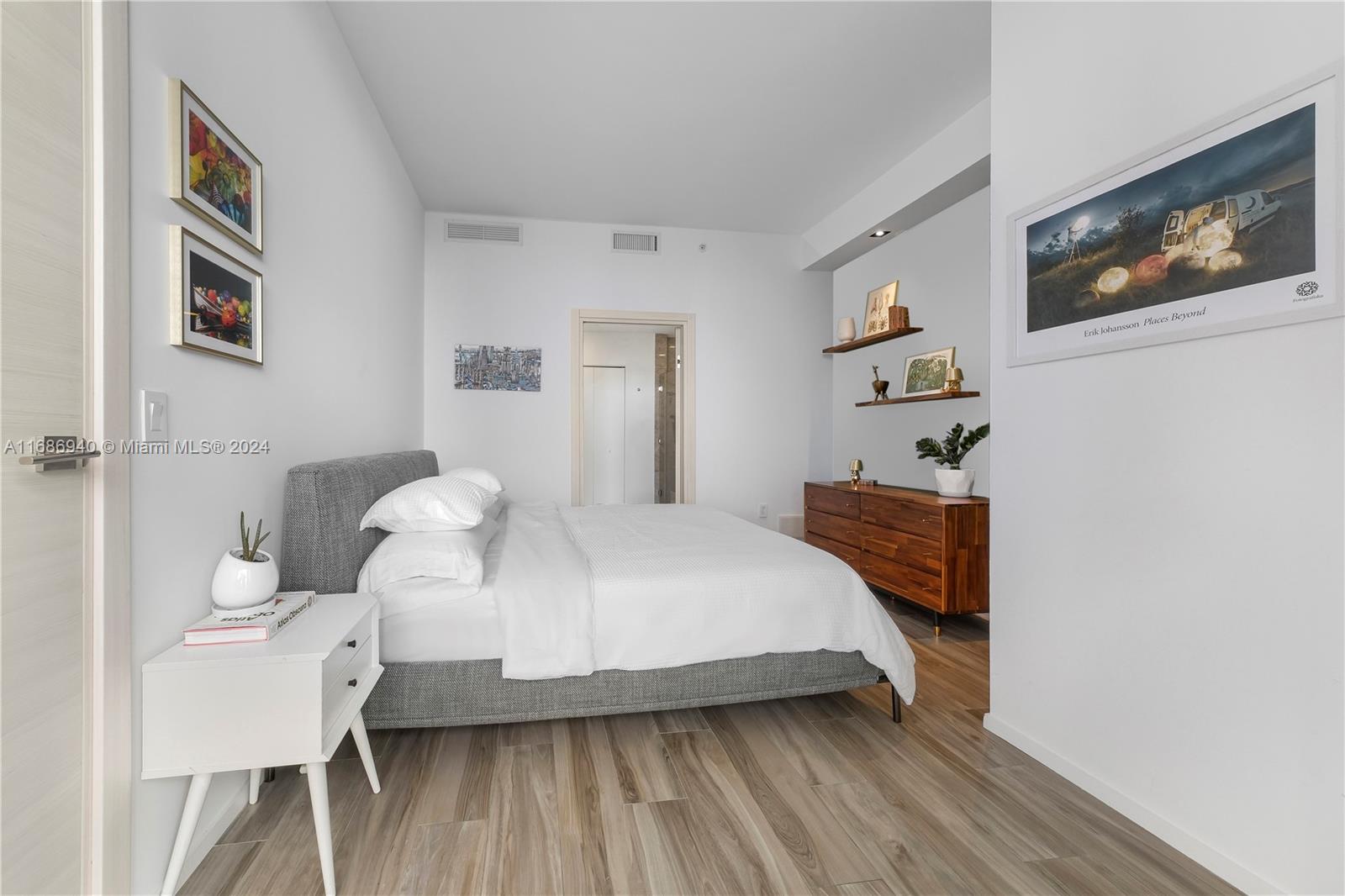 Brickell Miami, FL 33131 - Photo 8 of 13 a bedroom with a bed and wooden floor