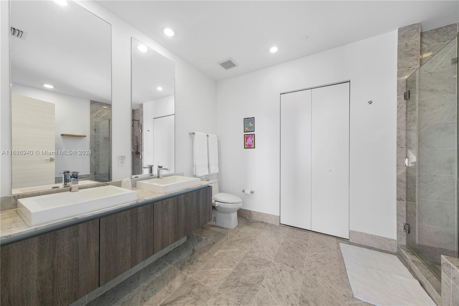 Brickell Miami, FL 33131 - Photo 9 of 13 a spacious bathroom with a double vanity sink mirror and toilet