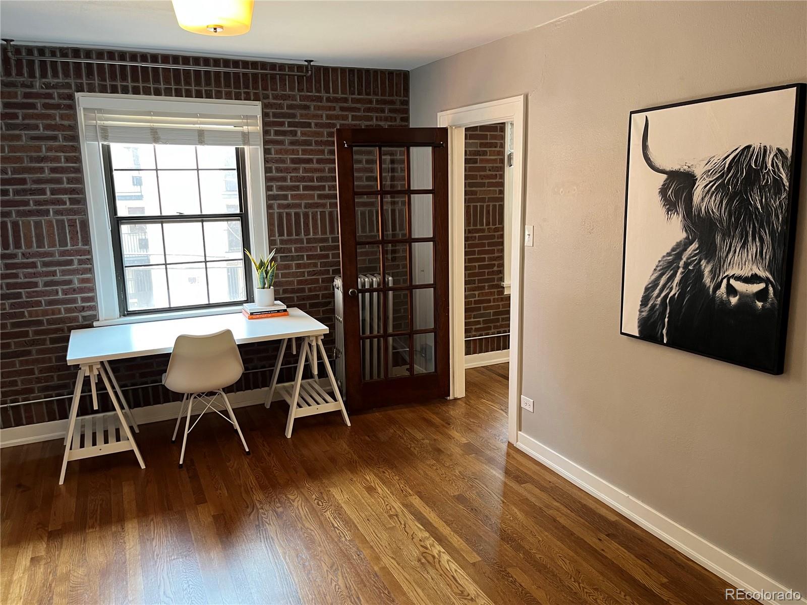 1684 Harrison Street, Unit 8 Denver, CO 80206 - Photo 9 of 21 a view of a dining room with furniture and wooden floor