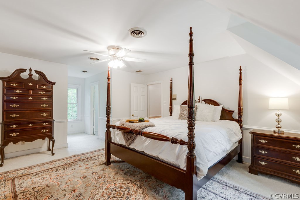 10200 Qualla Road Chesterfield, VA 23832 - Photo 4 of 47 a large bedroom with a bed a dresser and chandelier