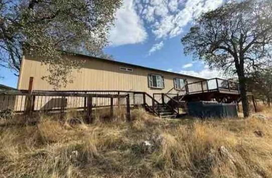 a backyard of a house with table and chairs